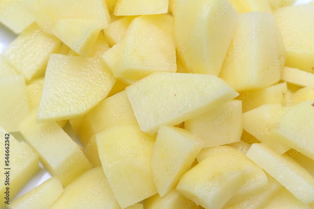 chopped potato. potato being prepared for meal. yellow natural food. chopped potato. potato being prepared for meal. yellow natural food.