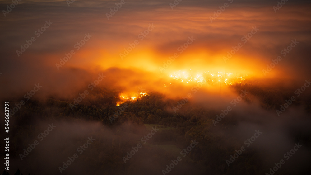 The lights of a village make the fog burn during an inversion in the Black Forest