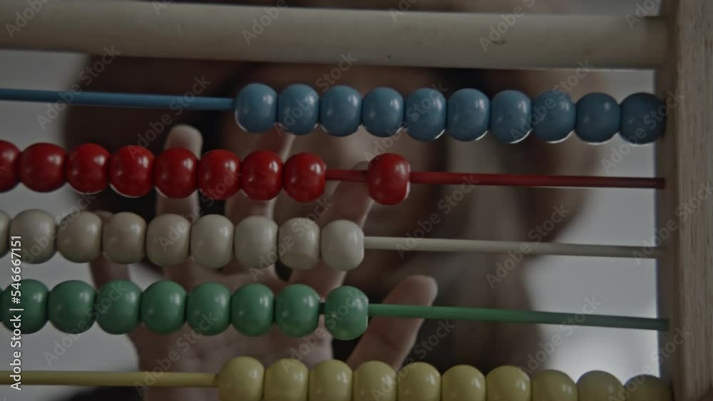 Young asian girl using a wooden abacus and calculator doing mathematics Young asian girl using a wooden abacus and calculator doing mathematics