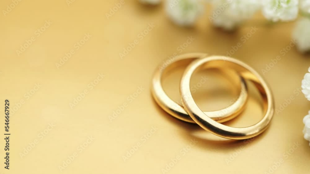 Gold wedding background with rings and soft light effects copy space for wedding invitation photo animation