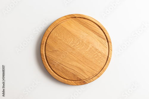 Empty wood round cutting board on white background