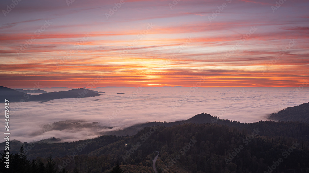 Sunset over the mist-covered entrance to the Murg Valley in the German Black Forest