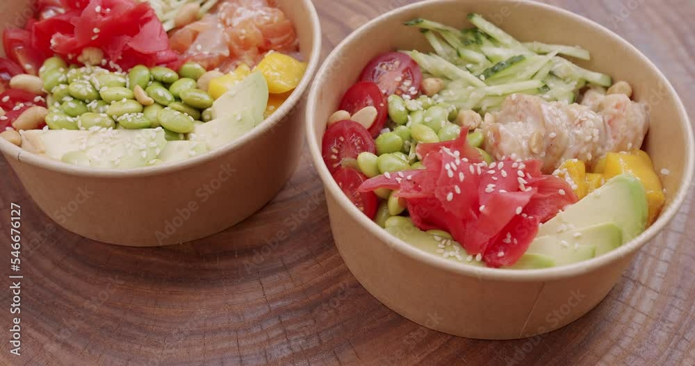 Poke bowl with salmon, shrimp, rice, avocado, edamame beans, cucumber on a wooden background. Healthy food, Asian raw meal. traditional Hawaiian raw fish salad. Poke bowl, Japanese food. Poke bowl with salmon, shrimp, rice, avocado, edamame beans, cucumber on a wooden background. Healthy food, Asian raw meal. traditional Hawaiian raw fish salad. Poke bowl, Japanese food.