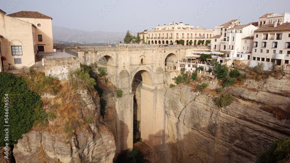 Aerial drone view of the New Bridge in Ronda. White villages in the province of Malaga, Andalusia, Spain. Beautiful village on the cliff of the mountain. Touristic destination. Holidays.