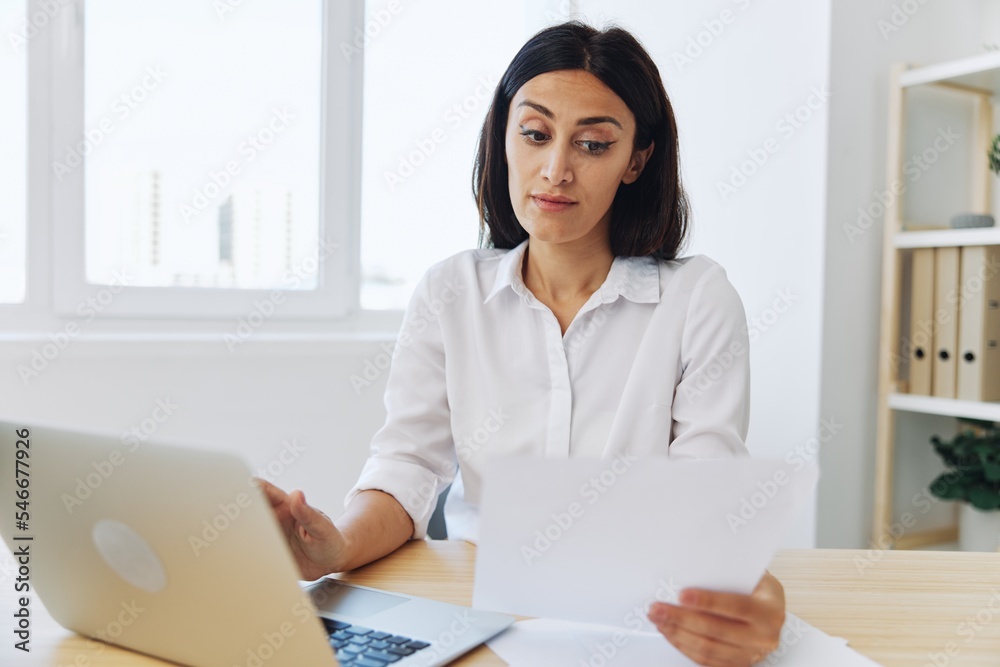 Woman business working at her laptop at home in her office, freelance employee in business, happiness of working online, technology in business