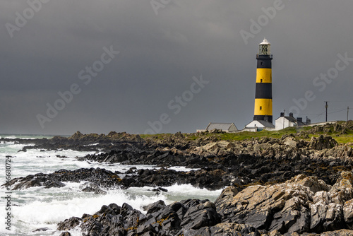 John's Point lighthouse, waves breaking on the coastline rocks of Northern Ireland