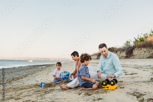 Family playing with toys at beach