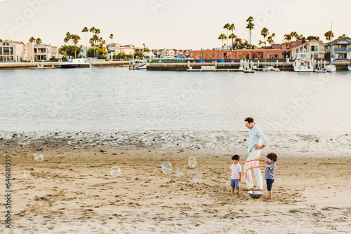 Father and sons on beach