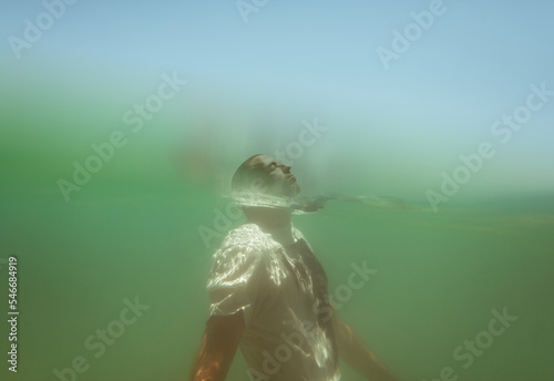 Underwater portrait of a man floating in the sea photo