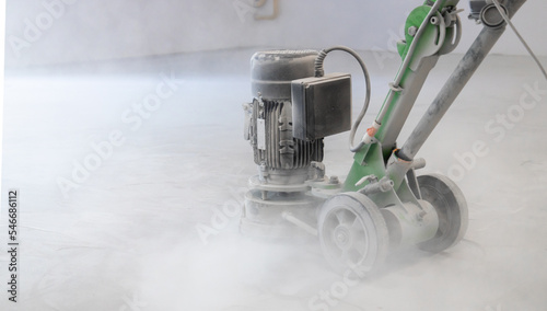 Concrete grinder, industrial equipment at work, concrete floor repair in industrial premises