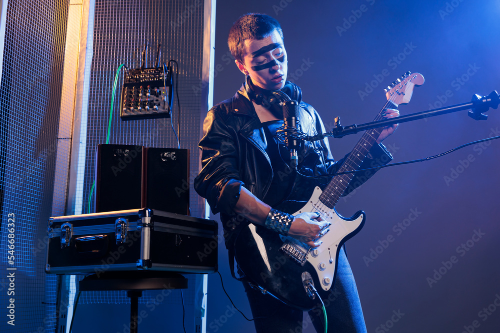 Solo artist performing live show playing guitar, feeling heavy metal