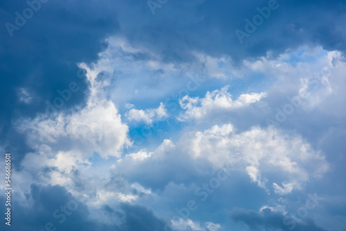 Thick blue clouds in front of a mountain