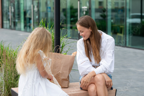 Mother with daughter in shopping center photo