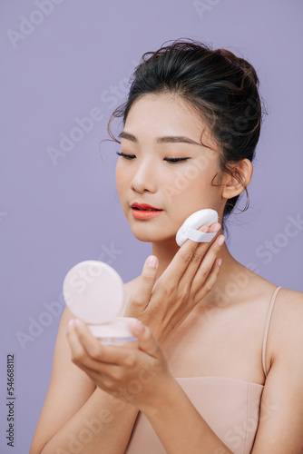 Cheerful girl using flawless smooth soft tone cream bb cc