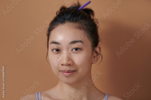 Asian Woman before make up and hair do style dresser.