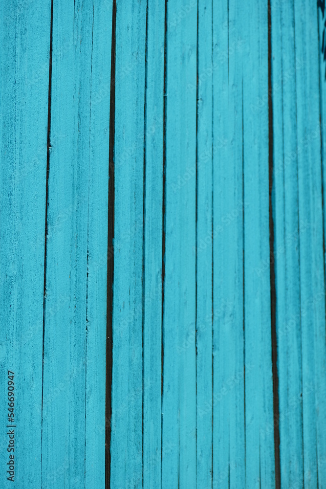 Fototapeta premium vibrant turquoise painted wood fence in full sun