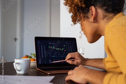 Focused businesswoman analyzing stock market data photo