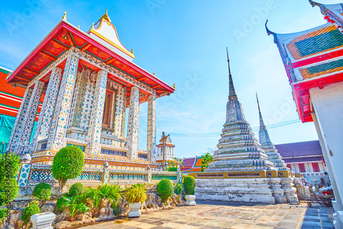 The enclosure of Wat Arun temple complex with numerous shrines and small chedies, Bangkok, Thailand photo