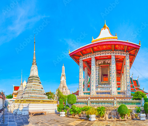 Colorful tiled shrines and chedies with main Prang of Wat Arun on background, Bangkok, Thailand photo