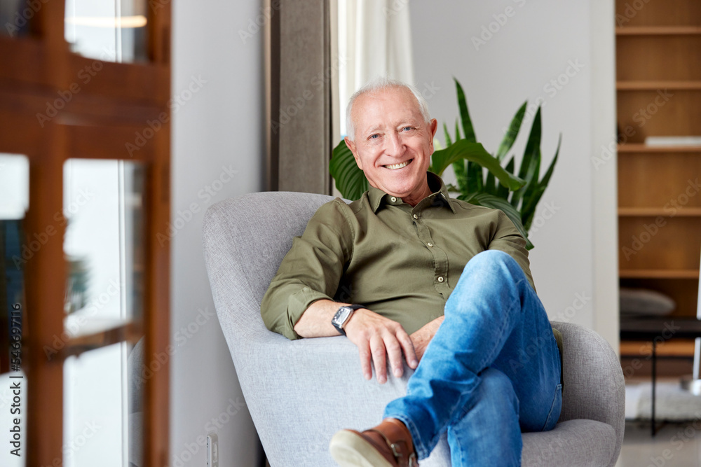 Cheerful senior man sitting in armchair Cheerful senior man sitting in armchair