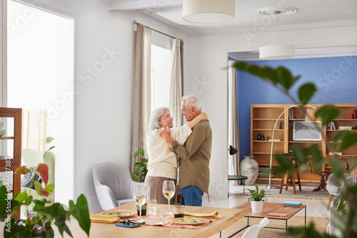 Loving pensioners dancing at home photo