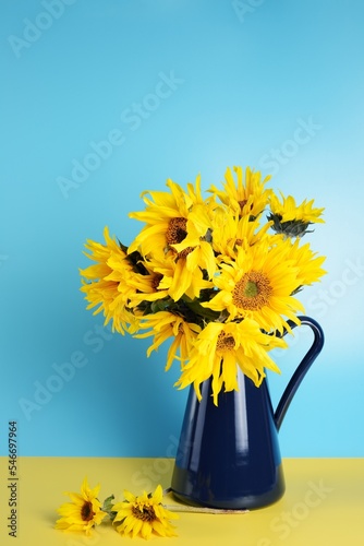 Beautiful sunflowers bouquet in a metal vase.
