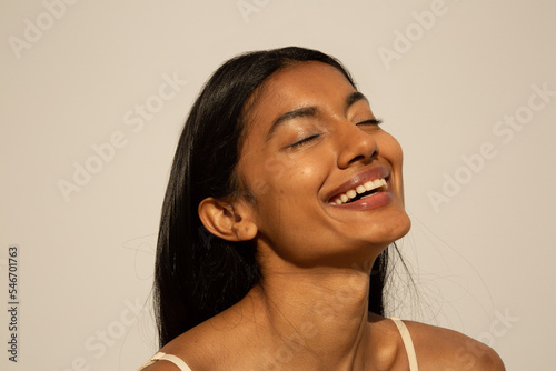 Woman enjoying the sun with glowing skin photo