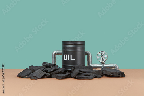 Black oi barrel and pieces of coal. photo