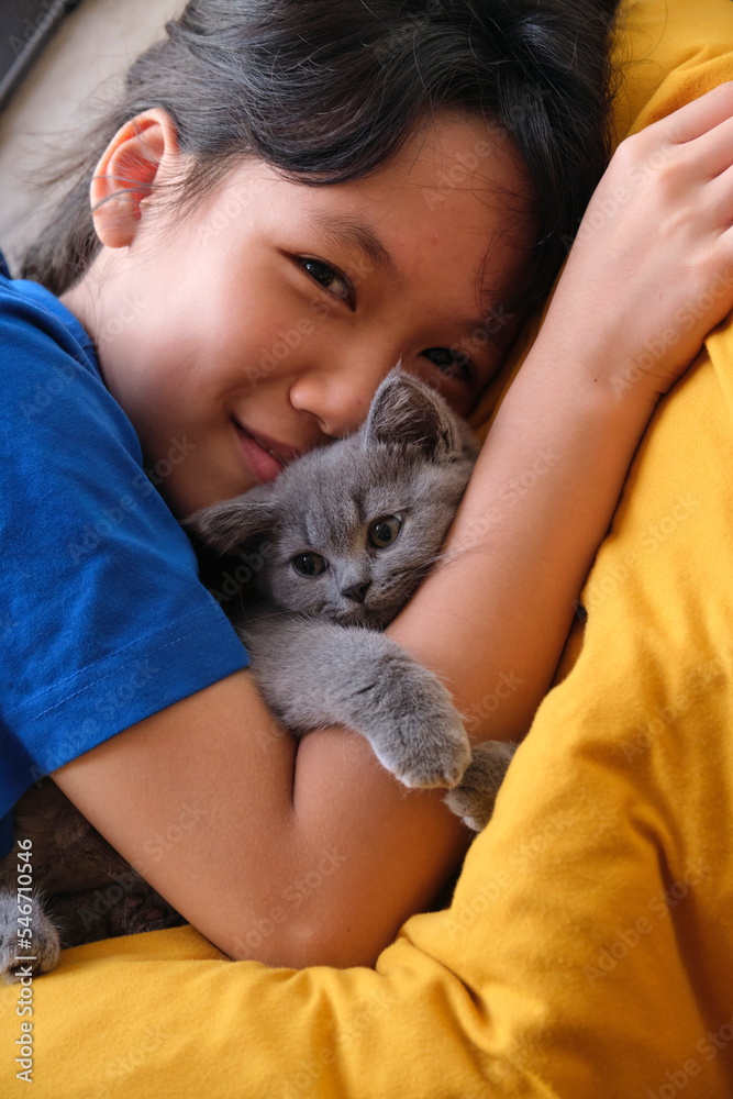 Closeup Asian girl and her pet cat in her arms Closeup Asian girl and her pet cat in her arms