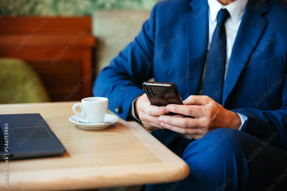 Crop businessman using smartphone in cafe Crop businessman using smartphone in cafe