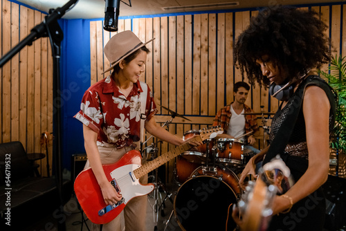 Two young women jamming with their guitars