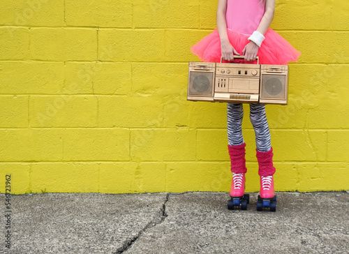 Girl Holding Music Box and Roller Skates photo