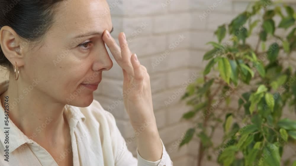 Female face massage for breathing. A pretty female practice face massage for better breathing in the room. Female face massage for breathing. A pretty female practice face massage for better breathing in the room.
