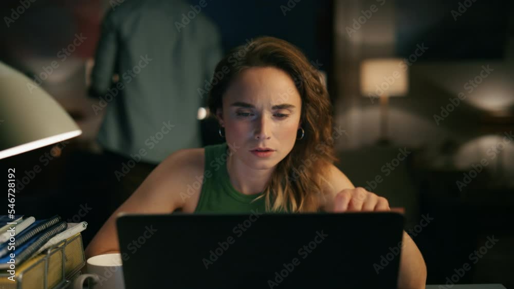 Focused girl reading computer at home office. Busy lady making notes closeup Focused girl reading computer at home office. Busy lady making notes closeup