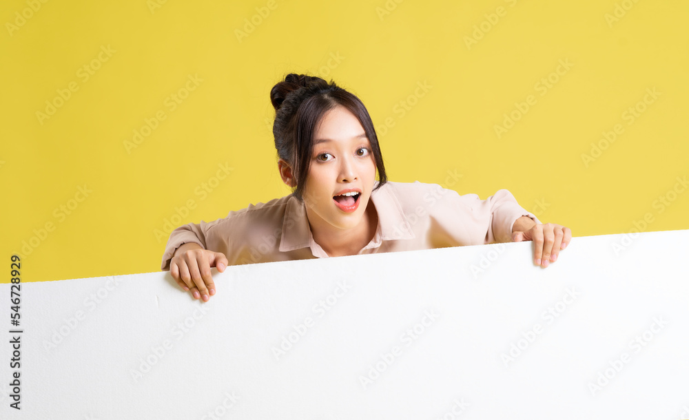 image of asian girl standing and posing with billboard image of asian girl standing and posing with billboard