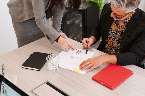 Mature businesspeople analyzing charts 