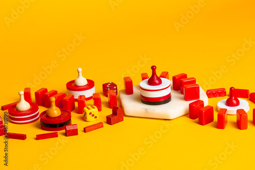 Red and yellow Board Game pieces and dice swirling photo