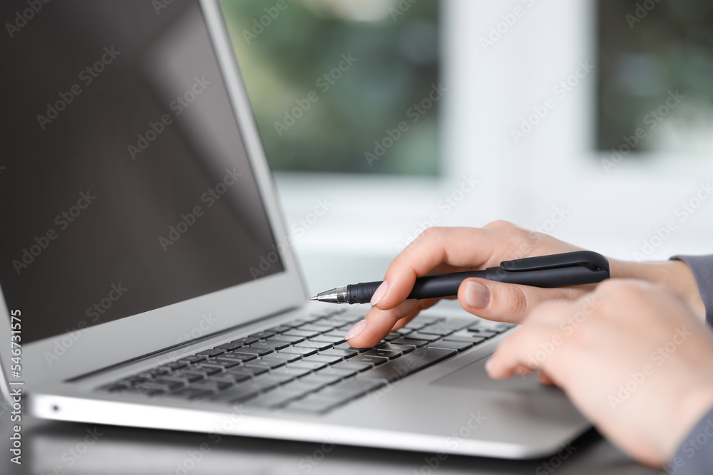 Woman working on laptop at table, closeup. Electronic document management Woman working on laptop at table, closeup. Electronic document management