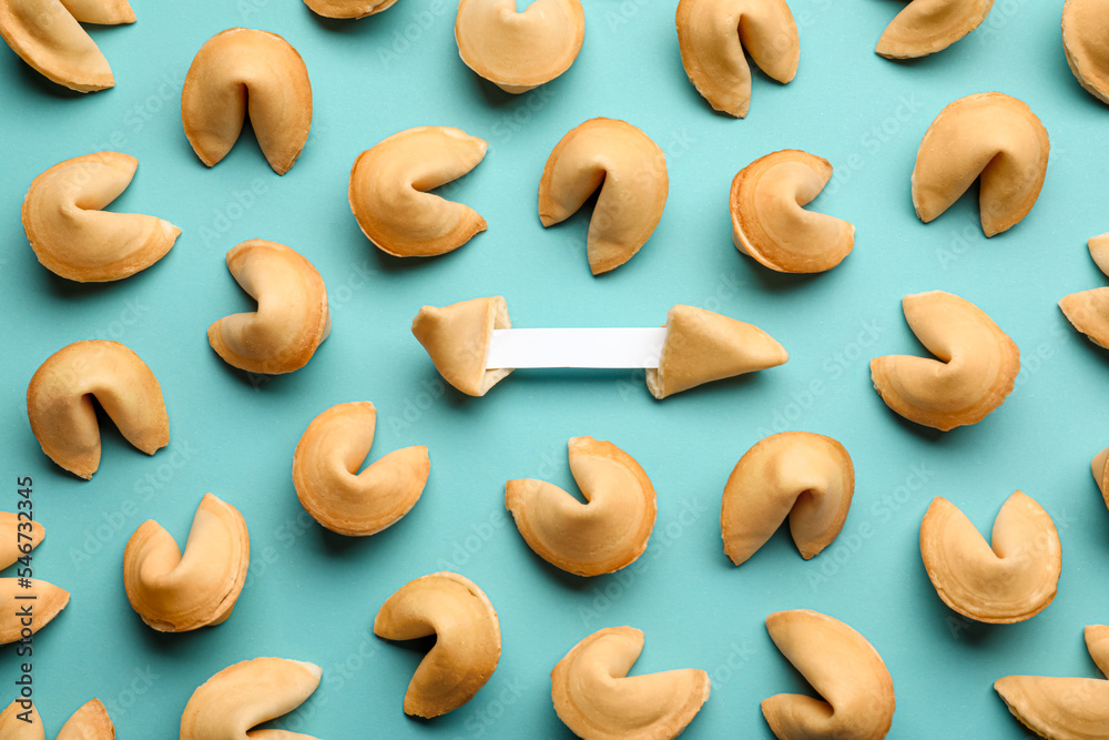 Tasty fortune cookies with predictions on light blue background, flat lay. Space for text Tasty fortune cookies with predictions on light blue background, flat lay. Space for text