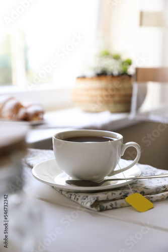Fototapeta Naklejka Na Ścianę i Meble -  Tea bag in cup on white wooden table indoors