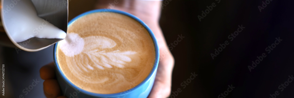 Barista pouring milk into cup of coffee on black background, closeup view with space for text. Banner design - obrazy, fototapety, plakaty 