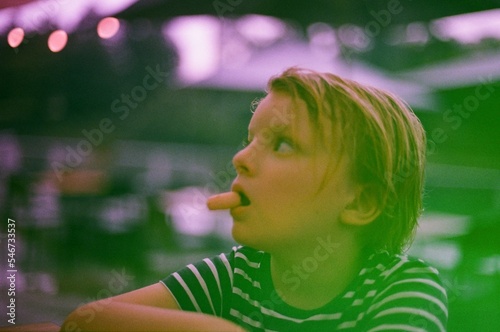 A boy eating breadstick in a bar