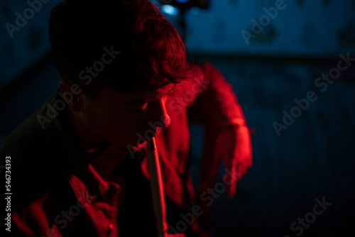 Man with hookah pipe at night