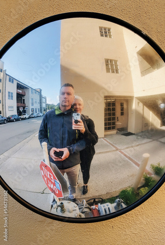 A couple takes a selfie in a mirror