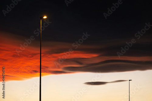 Street lamps under a dramatic sunset sky photo