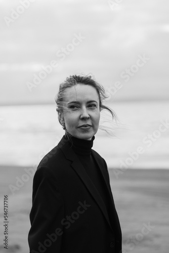 monochrome portrait of a beautiful woman on the empty beach in autumn photo