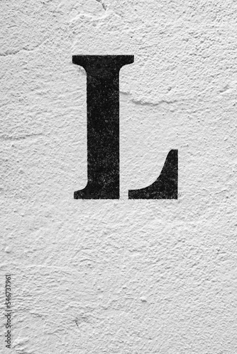 Distressed Brick Wall Background with a painted letter L. photo