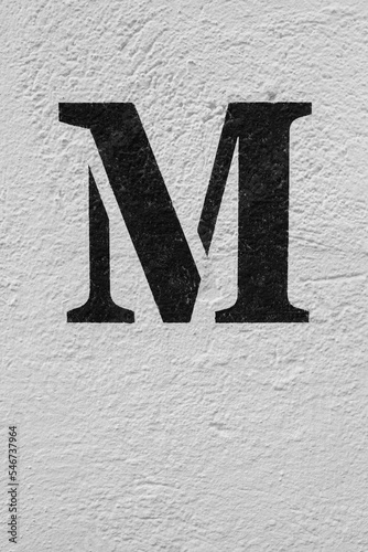 Distressed Brick Wall Background with a painted letter M. photo