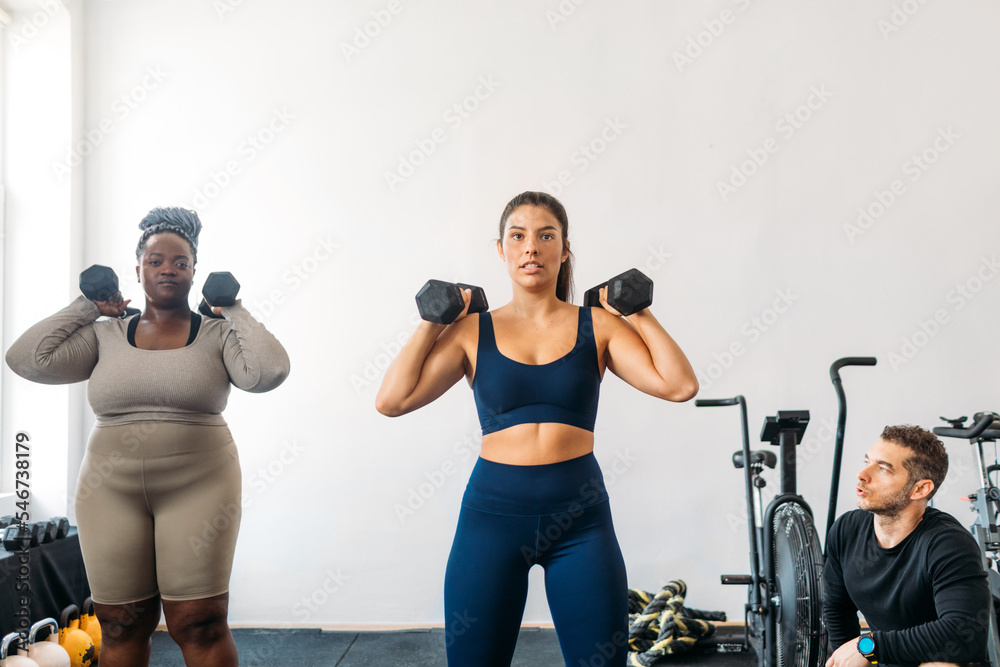 Women Exercising with Personal Trainer Women Exercising with Personal Trainer