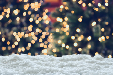 Empty white snow with blur Christmas tree with bokeh light background